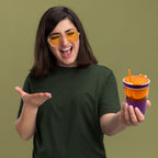 Portable snack and drink container, featuring a cup and snack compartment in one.