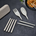Portable travel cutlery set with spoon, fork, and chopsticks.